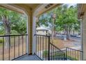 A serene view from the balcony, featuring mature trees and exterior building at 1051 S Hiawassee Rd # 2127, Orlando, FL 32835