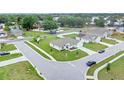 A corner lot home with a large manicured lawn, complemented by mature trees and a serene neighborhood at 1083 Snively Cir, Lake Hamilton, FL 33851