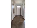 Inviting foyer showcasing tile flooring, a decorative window, and neutral paint tones, creating a welcoming entrance at 130 Highland Meadows St, Davenport, FL 33837