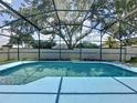 Inviting screened-in pool area with clear blue water and ample space for relaxation at 1301 Rebecca Dr, Haines City, FL 33844