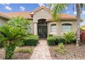Inviting front entrance with manicured bushes and double door entry at 133 Torino Ln, Kissimmee, FL 34759