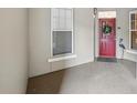 Inviting entryway with a red door adorned with a wreath, and a decorative heron statue at 1411 Celebration Ave # 106, Celebration, FL 34747