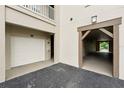 Attached garage and carport with wooden support beams, offering ample parking and storage at 1411 Celebration Ave # 106, Celebration, FL 34747