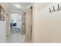 Elegant hallway with sliding barn doors, arched entryway, coat hooks, and tile flooring at 1411 Celebration Ave # 106, Celebration, FL 34747