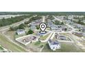 Aerial view showcasing a community with lush landscaping and a pin highlighting the property's location at 145 Willow Dr, Poinciana, FL 34759