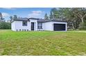 Beautiful single-story house with an attached two-car garage and manicured front yard at 16837 Sw 47Th Court Rd Rd, Ocala, FL 34473