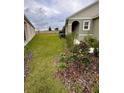 A spacious yard with well-kept lawn space separates the house from the guest house at 1791 Post Oak Dr, Davenport, FL 33837