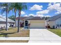 Charming single-story home with a two-car garage and well-maintained lawn and landscape at 2049 Shannon Lakes Blvd, Kissimmee, FL 34743