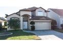 Inviting two-story home with an attached two-car garage and attractive landscaping at 2110 Korat Ln, Maitland, FL 32751