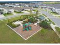 Aerial view of community playground with lush landscaping and Gathering friendly amenities in a neighborhood at 2279 Raven Ridge Road, Minneola, FL 34715