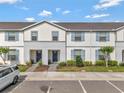 Inviting two-story townhome featuring a charming facade and well-maintained landscaping at 2408 Dubai St, Kissimmee, FL 34747