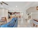 Bright and airy living space with tile flooring and an open staircase at 2408 Dubai St, Kissimmee, FL 34747