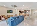 Open-concept living area with modern furnishings seamlessly connects to the gourmet kitchen at 2408 Dubai St, Kissimmee, FL 34747