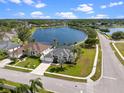 Aerial view of home with screened-in pool overlooking a large pond in a serene neighborhood at 3037 Diamond Ln, St Cloud, FL 34772