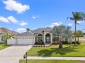 Beautiful home with manicured lawn, arched entryway, and a spacious two-car garage at 3037 Diamond Ln, St Cloud, FL 34772