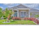 Inviting home featuring a cozy front porch with seating and a decorative front door at 3191 Marshfield Preserve Way, Kissimmee, FL 34746