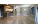 Spacious living area with tile floors and view of the kitchen and dining area at 3321 Whitestone Cir # 204, Kissimmee, FL 34741