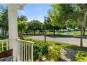 Scenic neighborhood view from front porch featuring pond and surrounding trees at 3535 Clay Brick Rd, Harmony, FL 34773