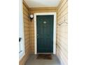 Cozy entrance featuring a green front door with a 