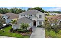 Beautiful two-story home with manicured lawn, elegant entryway, and a spacious driveway at 615 Copeland Dr, Haines City, FL 33844