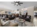 Spacious living room with staircase, ceiling fan, and open layout to the kitchen at 615 Copeland Dr, Haines City, FL 33844