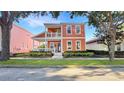 Charming two-story home with a inviting front porch and meticulously landscaped garden at 7422 Sparkling Ct, Reunion, FL 34747