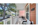 Relaxing front porch with comfortable seating, perfect for enjoying the neighborhood view at 7422 Sparkling Ct, Reunion, FL 34747