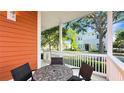 Cozy front porch features comfortable wicker furniture and views of the charming neighborhood at 7422 Sparkling Ct, Reunion, FL 34747