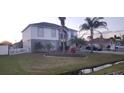 Two-story home showcasing manicured lawn, landscaped beds and an oversized driveway leading to an attached garage at 773 Leopard Ct, Kissimmee, FL 34759