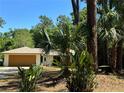 Beautiful home featuring a well-maintained lawn, mature trees and a two-car garage at 805 Hemlock Dr, Apopka, FL 32712