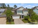 Charming home with a brick driveway, two-car garage, and lush landscaping at 8724 Peachtree Park Ct, Windermere, FL 34786