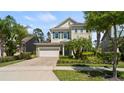 Beautiful home featuring manicured landscaping and a brick driveway at 8724 Peachtree Park Ct, Windermere, FL 34786