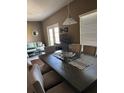 Open dining area with table, chairs, and decorative pendant lighting at 8981 Shine Dr, Kissimmee, FL 34747