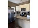 Well-equipped kitchen with granite countertops and stainless steel refrigerator at 8981 Shine Dr, Kissimmee, FL 34747