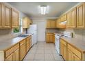 Functional kitchen featuring tile countertops, white appliances, and ample cabinet space for storage at 12513 Indiana Woods Ln, Orlando, FL 32824