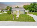 Charming home featuring a stone walkway leading to the front door and well-maintained landscaping at 1422 Missouri Ave, St Cloud, FL 34769