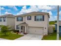 Two-story home featuring a two-car garage, manicured lawn, and neutral-toned facade at 164 Emanuelle Dr, Winter Haven, FL 33884