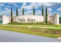 Stone 'Villa Mar' community sign with lush landscaping and manicured lawn at 164 Emanuelle Dr, Winter Haven, FL 33884