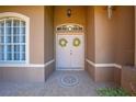 Grand double front doors with decorative wreaths, tile flooring, and a transom window create an elegant entry at 1941 Mathis Rd, St Cloud, FL 34771
