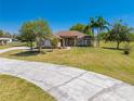 Inviting one-story home with well-kept grounds, a long driveway and lush landscaping at 1941 Mathis Rd, St Cloud, FL 34771