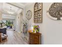 Inviting entryway with wood-look tile flooring, decorative wall art, and a charming console table at 1948 Molise Dr, Kissimmee, FL 34759