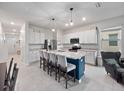 Stylish kitchen with stainless steel appliances and a spacious island with seating at 208 Feltrim Reserve Blvd, Davenport, FL 33837