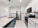 Well-equipped kitchen featuring stainless steel appliances and ample counter space at 208 Feltrim Reserve Blvd, Davenport, FL 33837