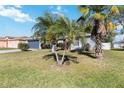 Exterior view of a well maintained home with lush green lawn and palm trees at 218 Cranbrook Dr, Kissimmee, FL 34758