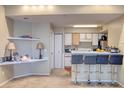 Open-concept living room with breakfast bar and built in shelving, great for entertaining at 2203 Key West Ct # 432, Kissimmee, FL 34741