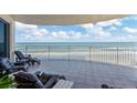 Enjoy breathtaking ocean views from this spacious tiled balcony with comfortable lounge chairs at 2403 S Atlantic Ave # 501, Daytona Beach Shores, FL 32118