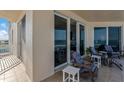 Relax on this covered balcony with seating and views of the ocean through large glass sliders at 2403 S Atlantic Ave # 501, Daytona Beach Shores, FL 32118