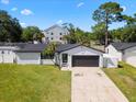 Single-story home featuring a well-maintained lawn, driveway, and attached two-car garage at 2506 Bali Cir, Kissimmee, FL 34741