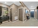 Inviting foyer featuring neutral paint and tile flooring, creating an elegant and welcoming entry space at 2874 Turnstone Run, Harmony, FL 34773