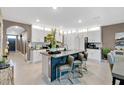 Stylish kitchen island with bar seating, ample storage, and modern finishes, perfect for entertaining guests at 2874 Turnstone Run, Harmony, FL 34773